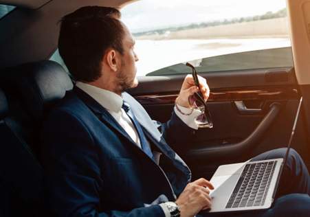 Man with Glasses Using Laptop in Luxury Car, RNR