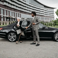 Professional Chauffeur Opening Door of Black Car, RNR